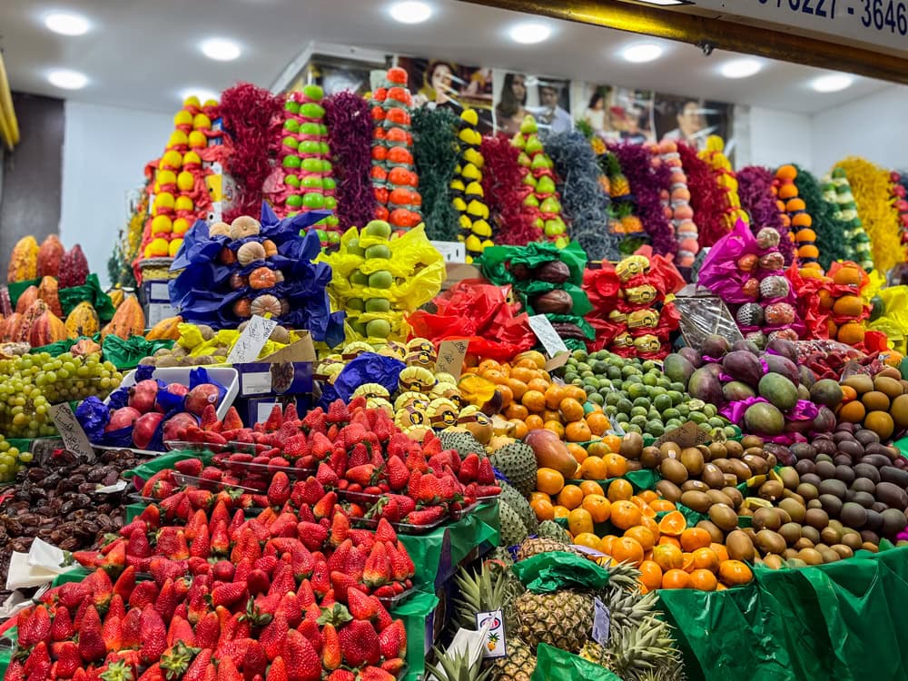 Piles of various exotic fruit at a market stand at Sao Paulo's Municipal Market. Exploring this vibrant market it one of the best things to do in São Paulo.