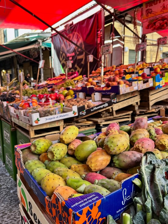 Boxes full of green, yellow and pink cactus fruits sold at Ballaro market in Palermo.