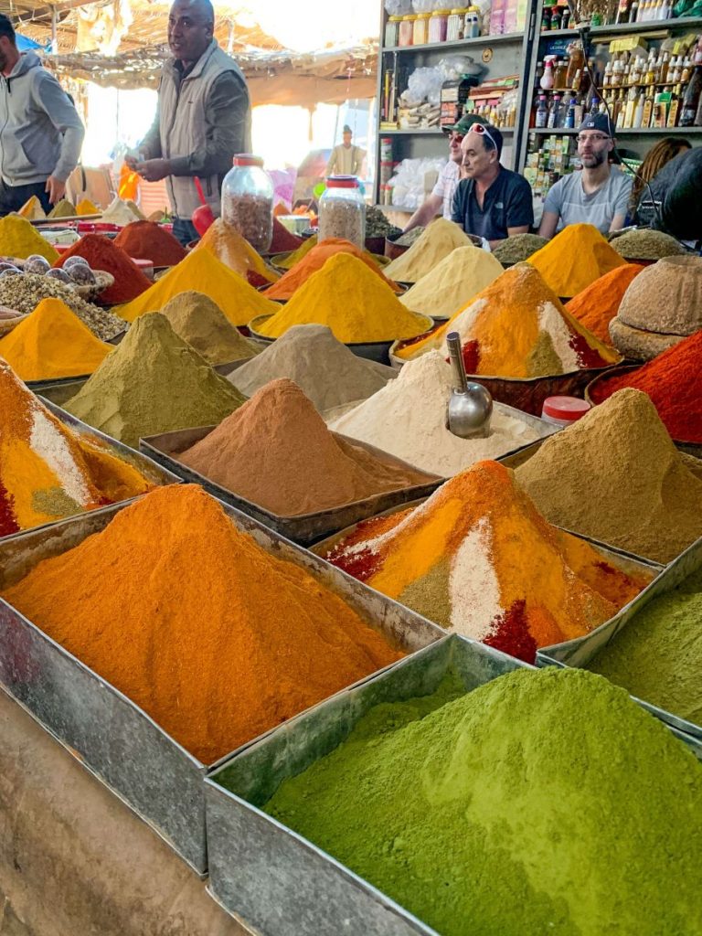 piles of colorful spices at a market in Morocco