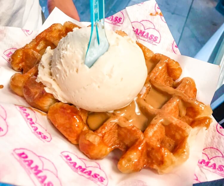 Fresh Belgian waffle with hazelnut ice cream and speculoos paste, a local specialty and one of the best foods to try in Brussels
