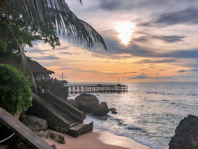 a sunset on a beach in Bali, Indonesia