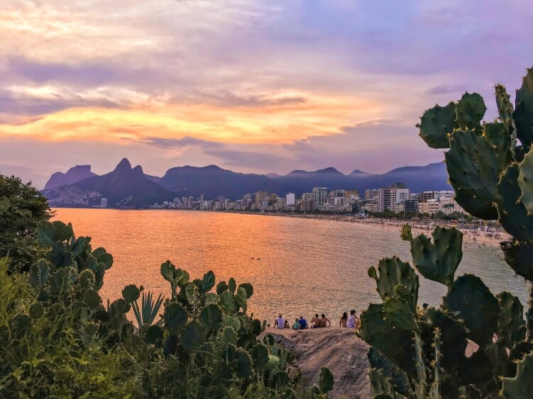 The sunset view from Arpoador cliff over Ipanema beach and the Two Brothers Mountains (Morro Dois Irmaos)