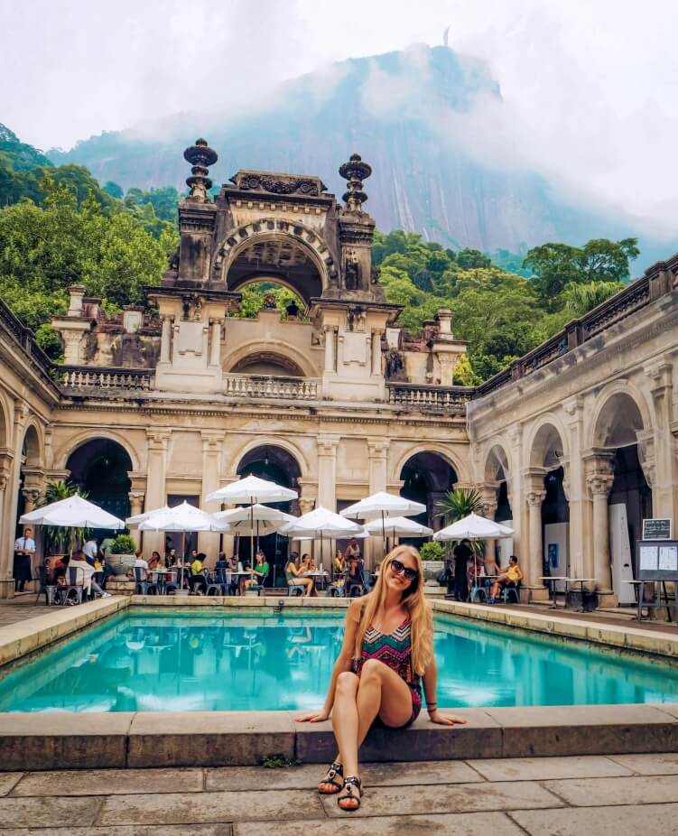 Turquoise pool in front of the Parque Lage cafe and a backdrop of Corcovado mountain topped by the Christ the Redeemer statue
