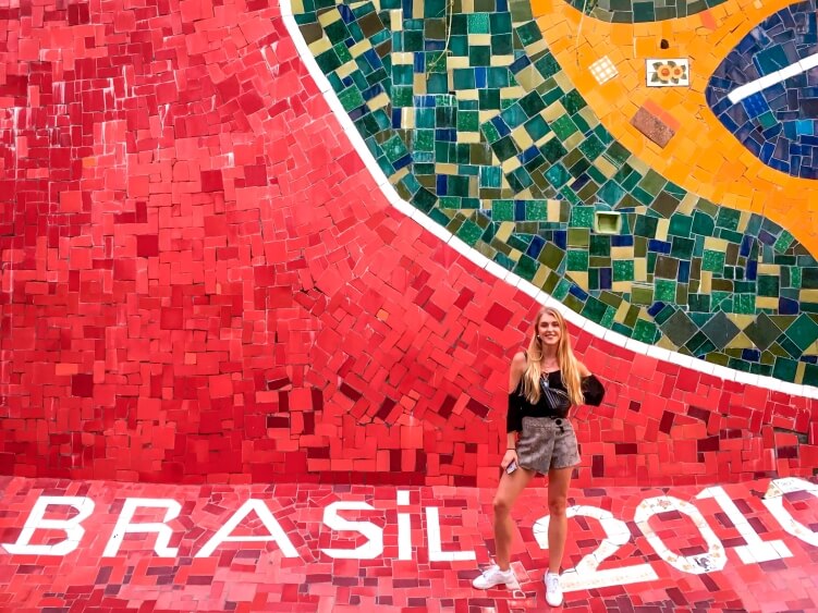 Me posing in front of the colorful tiled wall of Selaron stairs (Escadaria Selaron) in Rio de Janeiro, Brazil