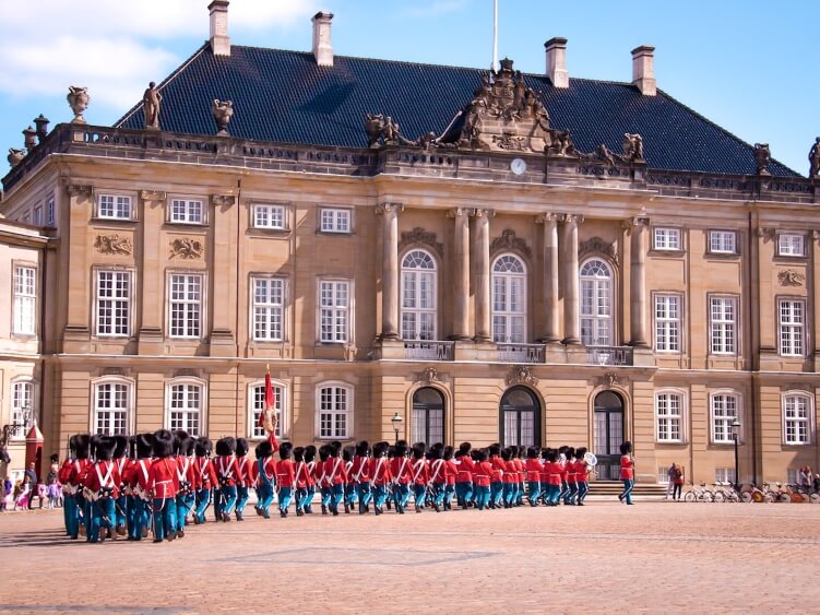 Soldiers marching in front of Amalienborg Palace, the residence of  the royal family of Denmark