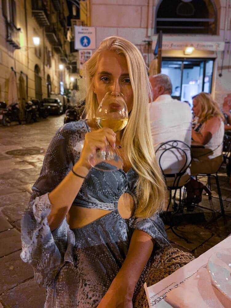 Me sipping wine in an outdoor restaurant in Palermo