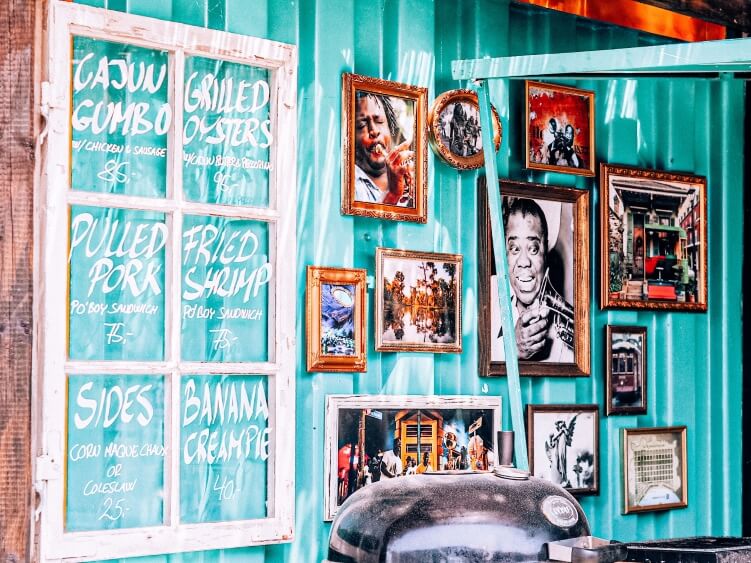 A turquoise blue wall of a food truck selling cajun cuisine at Reffen