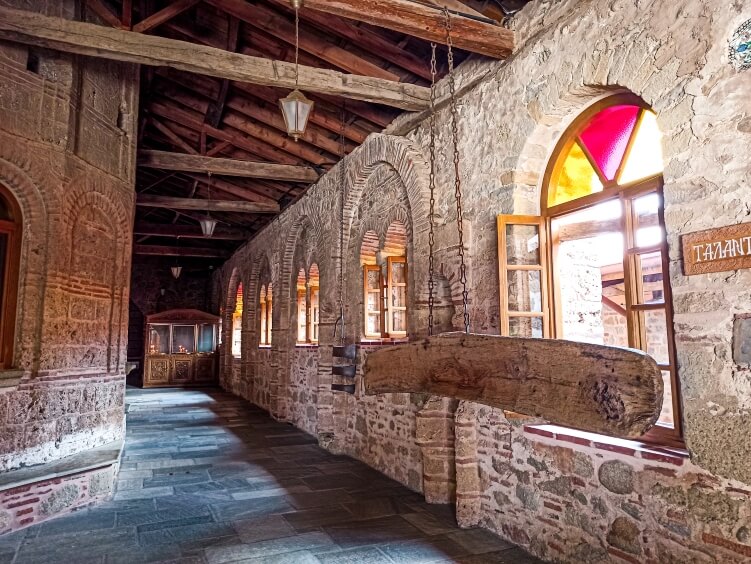 Beige brick walls and colorful windows of the Great Meteoron Monastery in Greece; one of the best things to do in Meteora