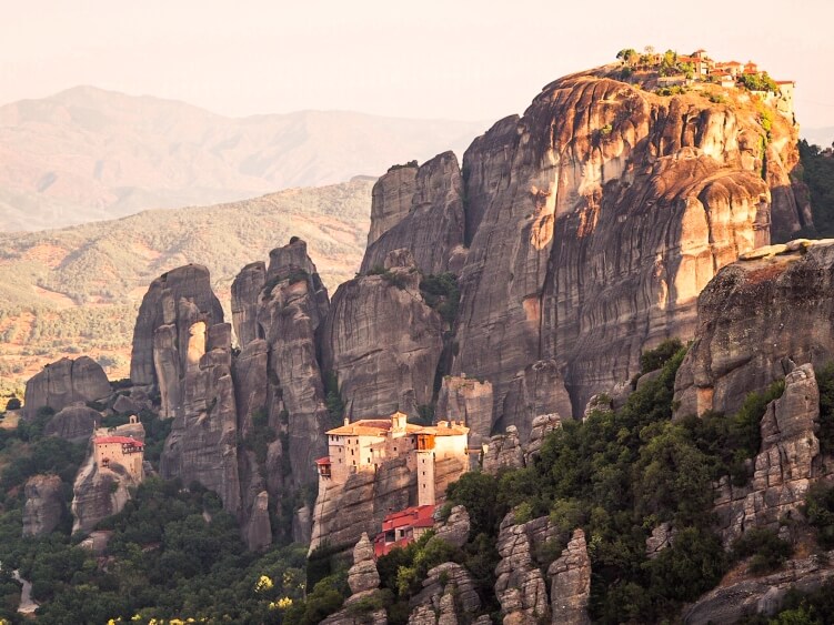 View over Roussanou Monastery perched on top of a narrow rock column in Meteora, Greece