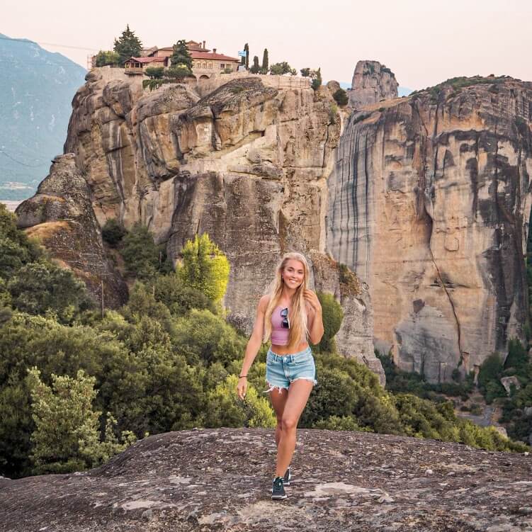 A girl hiking in Meteora during sunrise - one of the best things you can do in Meteora