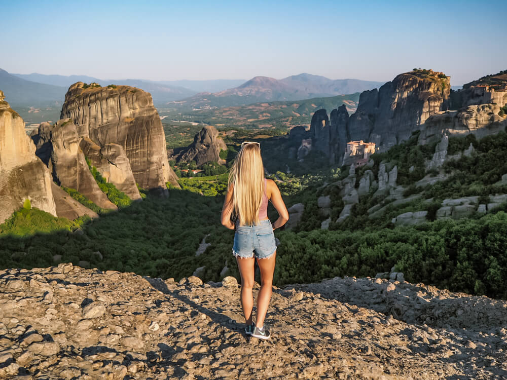 Me looking at the view of the giant rocks surrounding a green valley at the main viewpoint of Meteora.