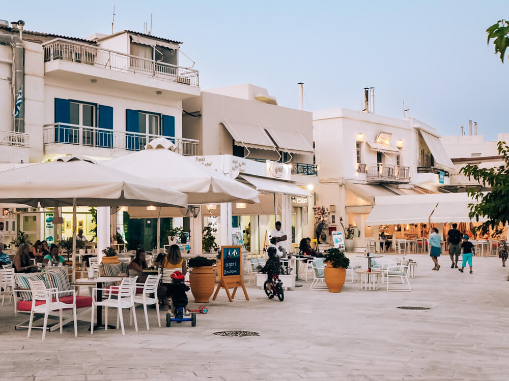 A series of restaurants with outdoor seating areas in the center of Adamantas.