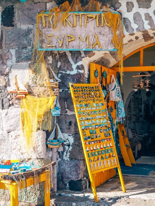 A selection of handicrafts and yellow decorations in a souvenir shop in the village of Klima