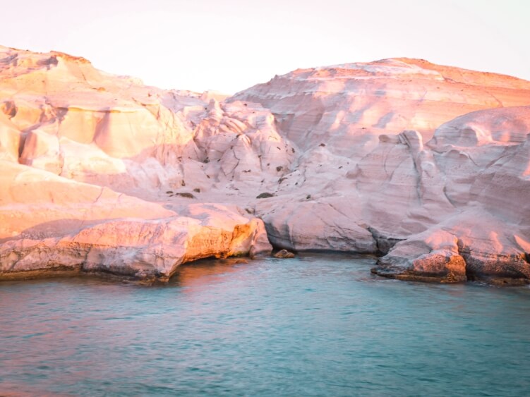 Emerald waters and white lunar landscapes of Sarakiniko Beach in Milos at sunrise