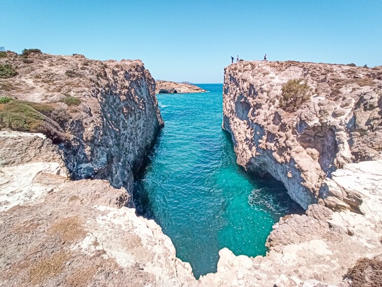 The narrow canal and crystal clear waters of Papafragas beach, one of the most unique and best beaches in Milos