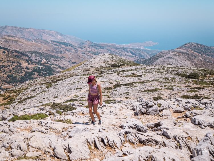 Me hiking up the rocky terrain on Mount Zeus, the highest mountain in the Cyclades and one of the best hikes in Greece