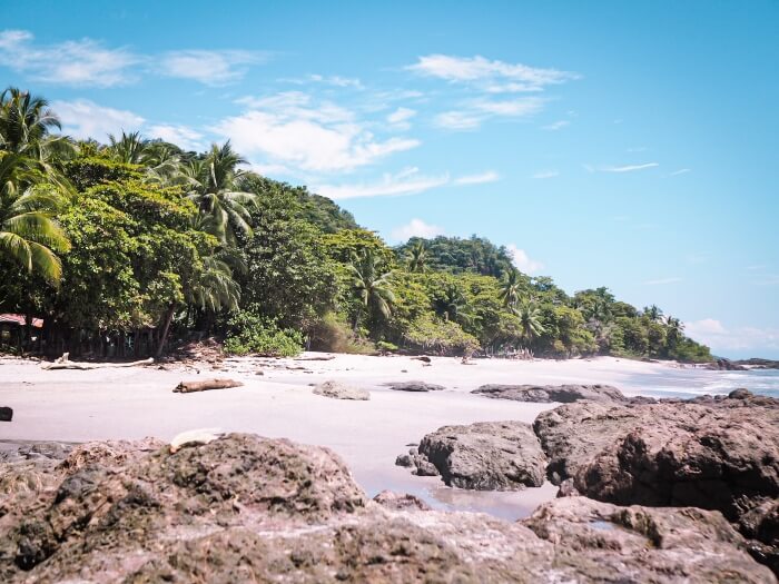 Big rocks on Montezuma beach in Costa Rica on a sunny day, one of the best places in this Costa Rica itinerary