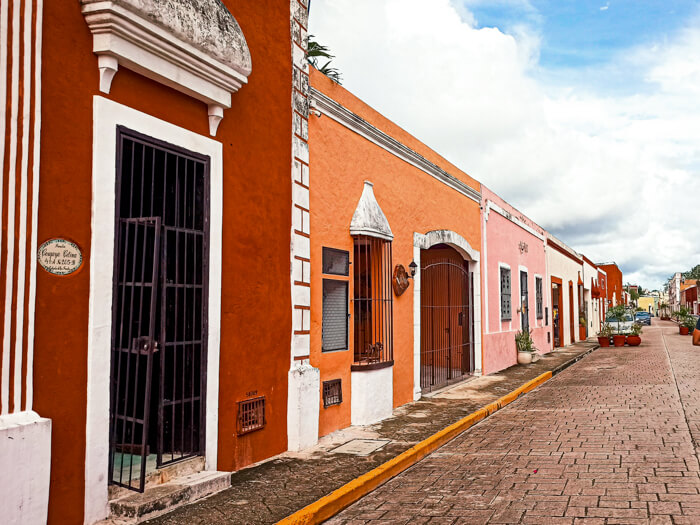 Small historical houses in orange, pink and red; seeing the colonial architecture is a must when visiting Valladolid, Mexico
