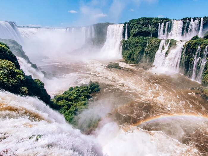 a view of the thundering cascades of Garganta del Diablo aka Devil's Throat and a rainbow at Brazilian Iguazu Falls