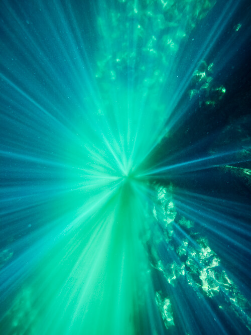 sun rays in the crystal clear water of Las Grietas, Galapagos Islands