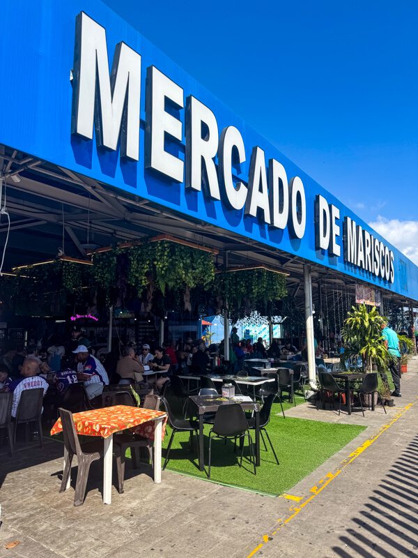 A big Mercado de Mariscos sign above a series of restaurants at Panama City's seafood market.