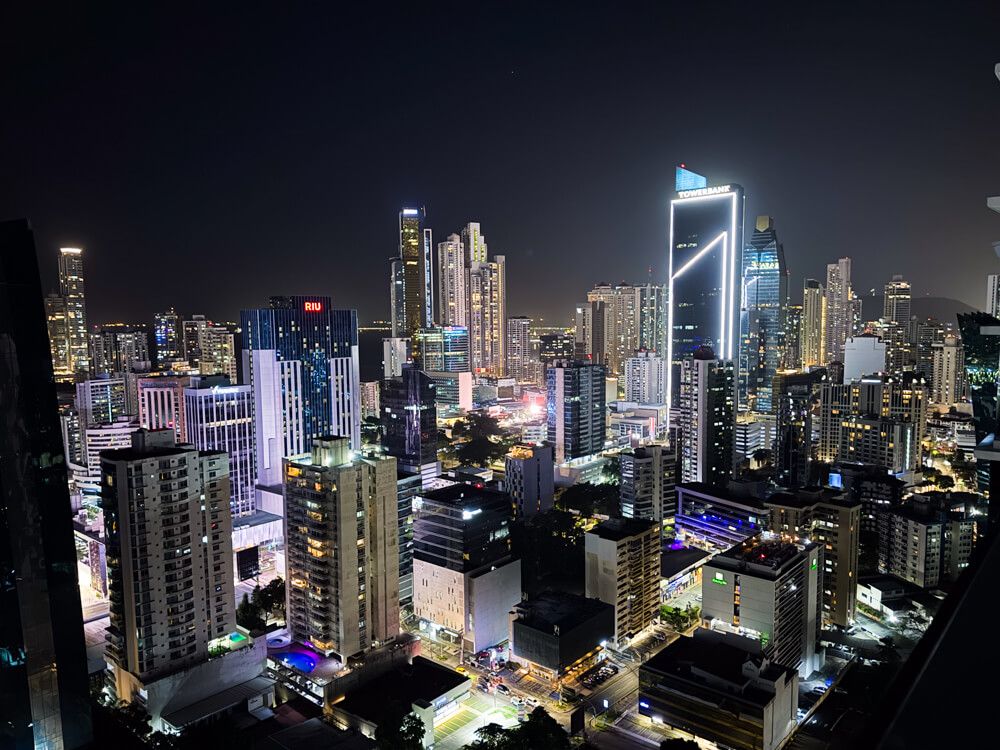 An aerial view of the skyscrapers of Panama City's business district at night.