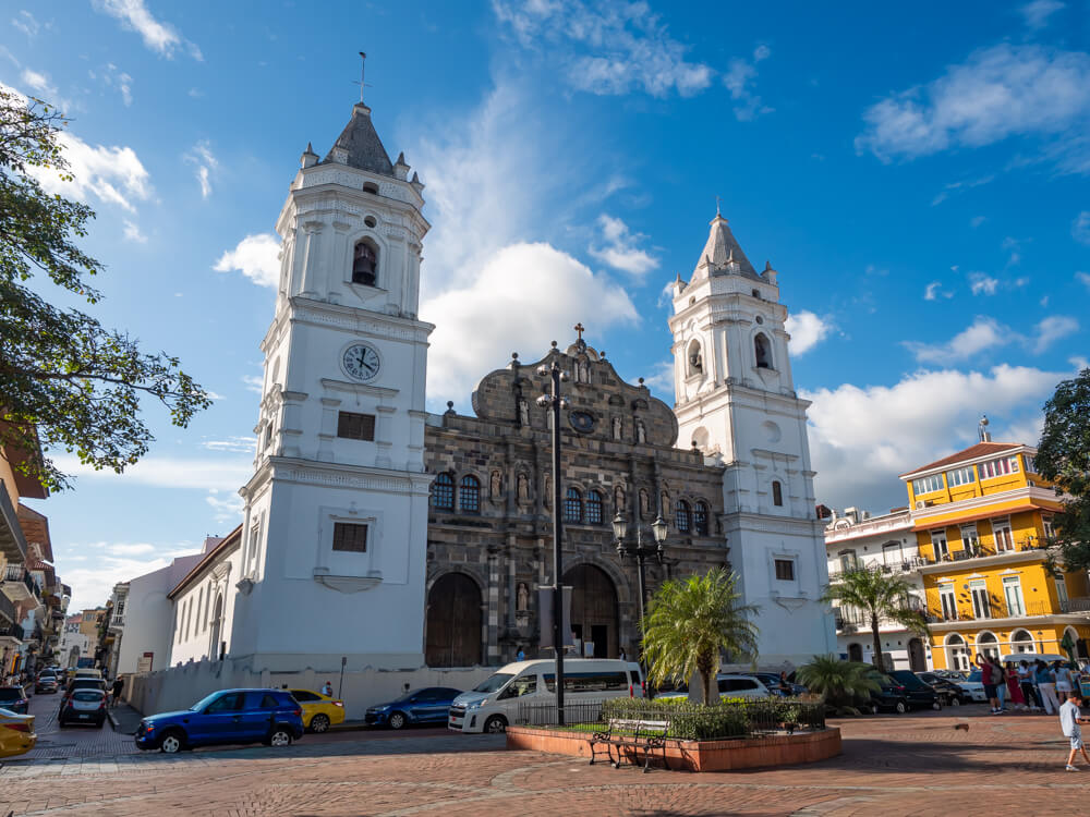 Panama Metropolitan Cathedral with its two white bell towers and a facade with intricate carvings.