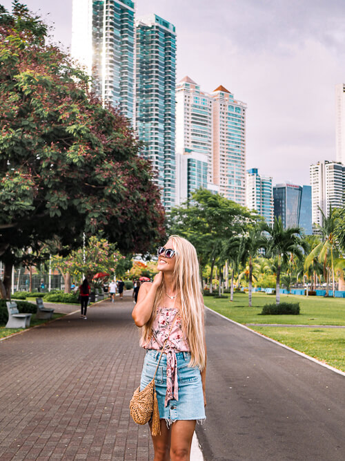 a girl walking on Cinta Costera, a coastal park and boardwalk