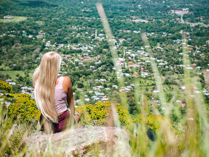 Me sitting on a rock and enjoying the view of El Valle de Anton, one of the best hiking destinations in Panama.