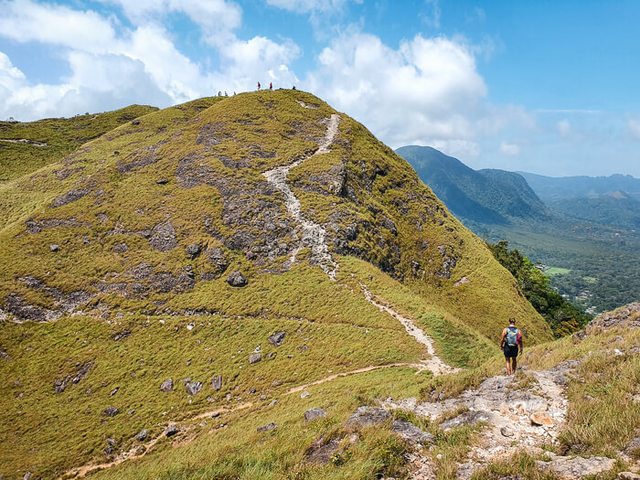 Steep grass-covered hills and a narrow trail of the La India Dormida hike, one of the best things to do in El Valle de Anton