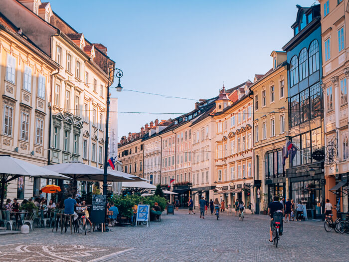 Cobblestone street lined with historical buildings in the old town of Ljubljana.