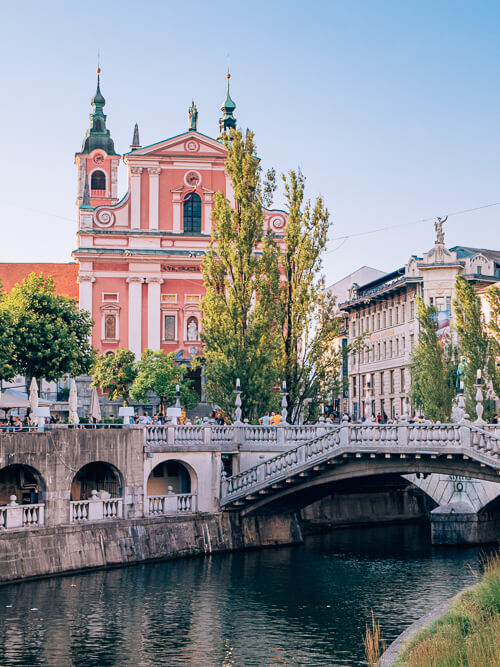 Pink Franciscan Church and a bridge in Ljubljana, Slovenia