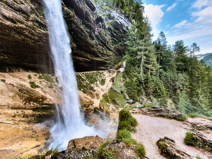 White cascading water of Pericnik Waterfall, a beautiful attraction to include in your Slovenia itinerary.