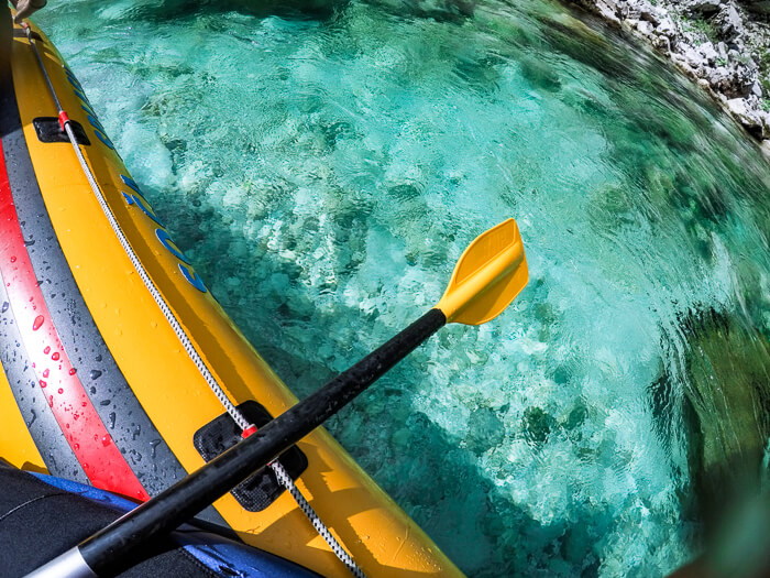 Rafting along a beautiful turquoise river in Slovenia, the perfect outdoor activity for families visiting Bovec.