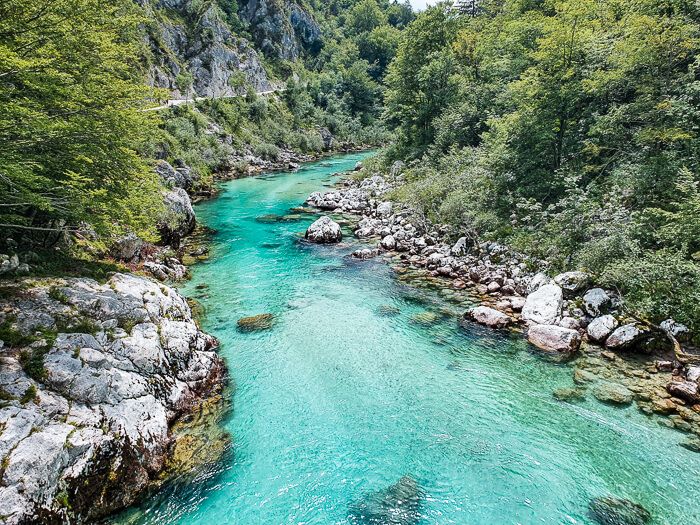 The turquoise blue Soca River surrounded by Julian Alps is one of the best places to visit in Slovenia