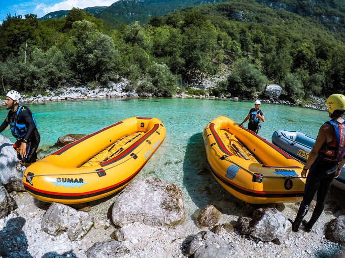 Yellow inflatable rafts lying on the river bed of the emerald Soca River near the town of Bovec