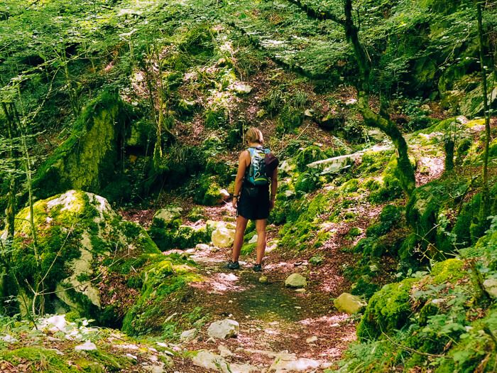 My boyfriend walking through a lush unspoiled forest along a hiking trail in Zagori, Greece.
