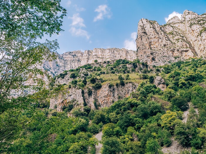 Views of dolomite and limestone cliffs when hiking Vikos Gorge among Greece's Pindus Mountains.