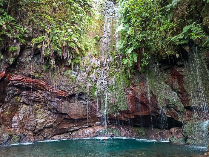 Small waterfalls, blue lagoon and lush foliage at the 25 Fontes levada walk.