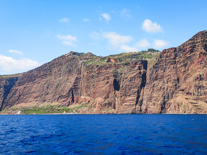 Cabo Girão cliff seen from a boat during a dolphin and whale watching tour in Funchal.