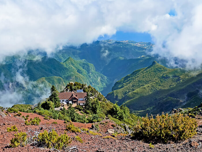 A mountain hut surrounded by clouds at Pico Ruivo, a must visit spot if you have 7 days in Madeira