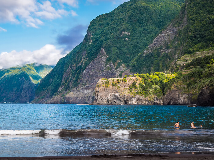 Seixal Beach with black sand and a backdrop of green mountains, one of the best sandy beaches in Madeira