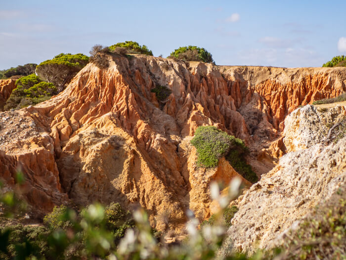 ochre-colored craggy hills along the Seven Hanging Valleys trail, one of the top hikes in the Algarve in southern Portugal