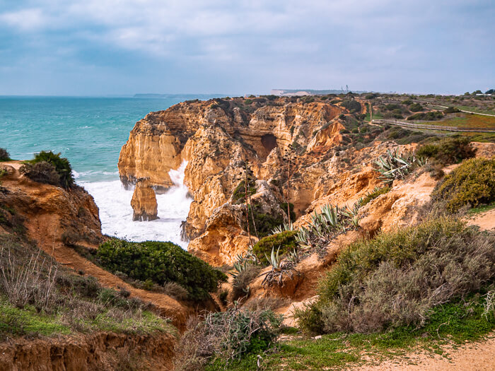 Rugged golden cliffs pounded by strong Atlantic Ocean waves at Ponta da Piedade, one of the highlights of this Algarve itinerary