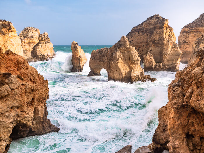 a small cove surrounded by limestone arches at Ponta da Piedade, one of the most beautiful Algarve hikes and a part of the Fishermen's Trail