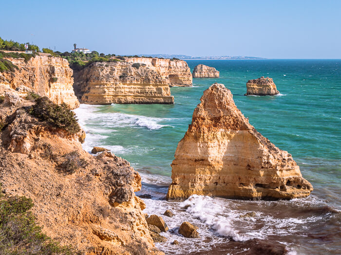 Limestone sea stacks and cliffs rising from the sea at the Seven Hanging Valleys trail along the Algarve coast of Portugal