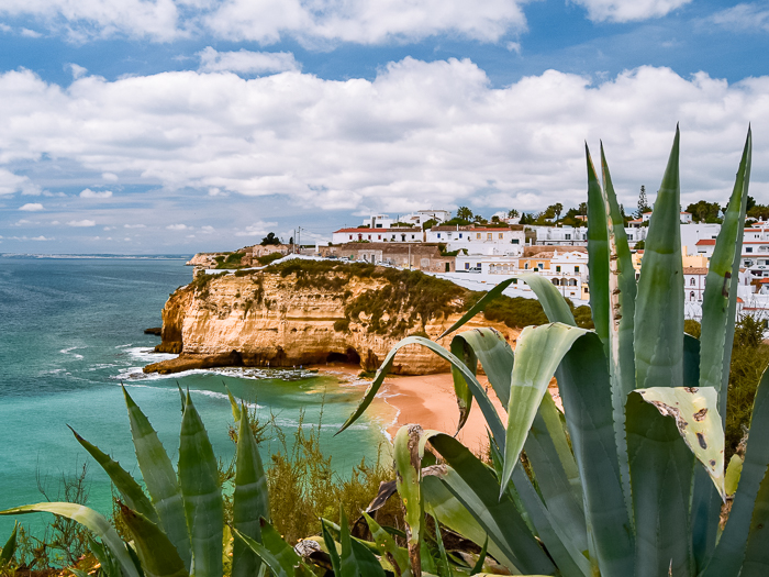 sandy Carvoeiro Beach surrounded by limestone cliffs, whitewashed houses and turquoise water