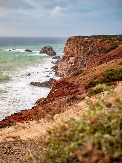 Coastal red cliffs at Pontal da Carrapateira headland hiking trail