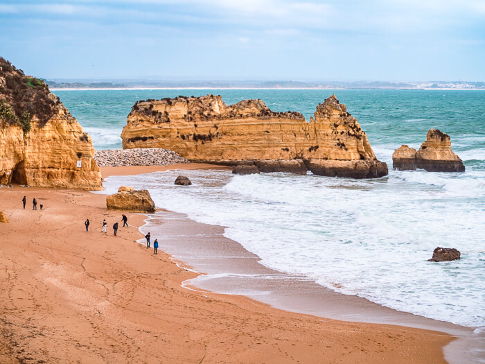 Sea stacks and a large stretch of sand at Praia da Dona Ana beach near Lagos, Portugal