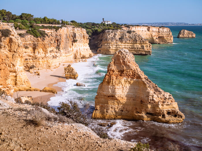 Steep cliffs and rock formations at Praia da Marinha beach, a highlight of every Algarve road trip